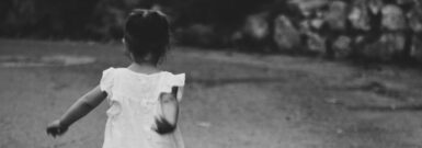 gray scale photography of girl walking towards destination