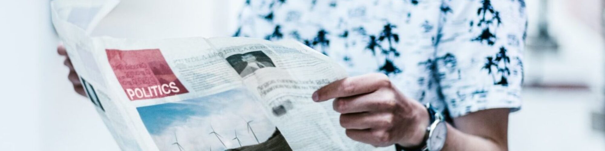 selective focus photography of person holding newspaper